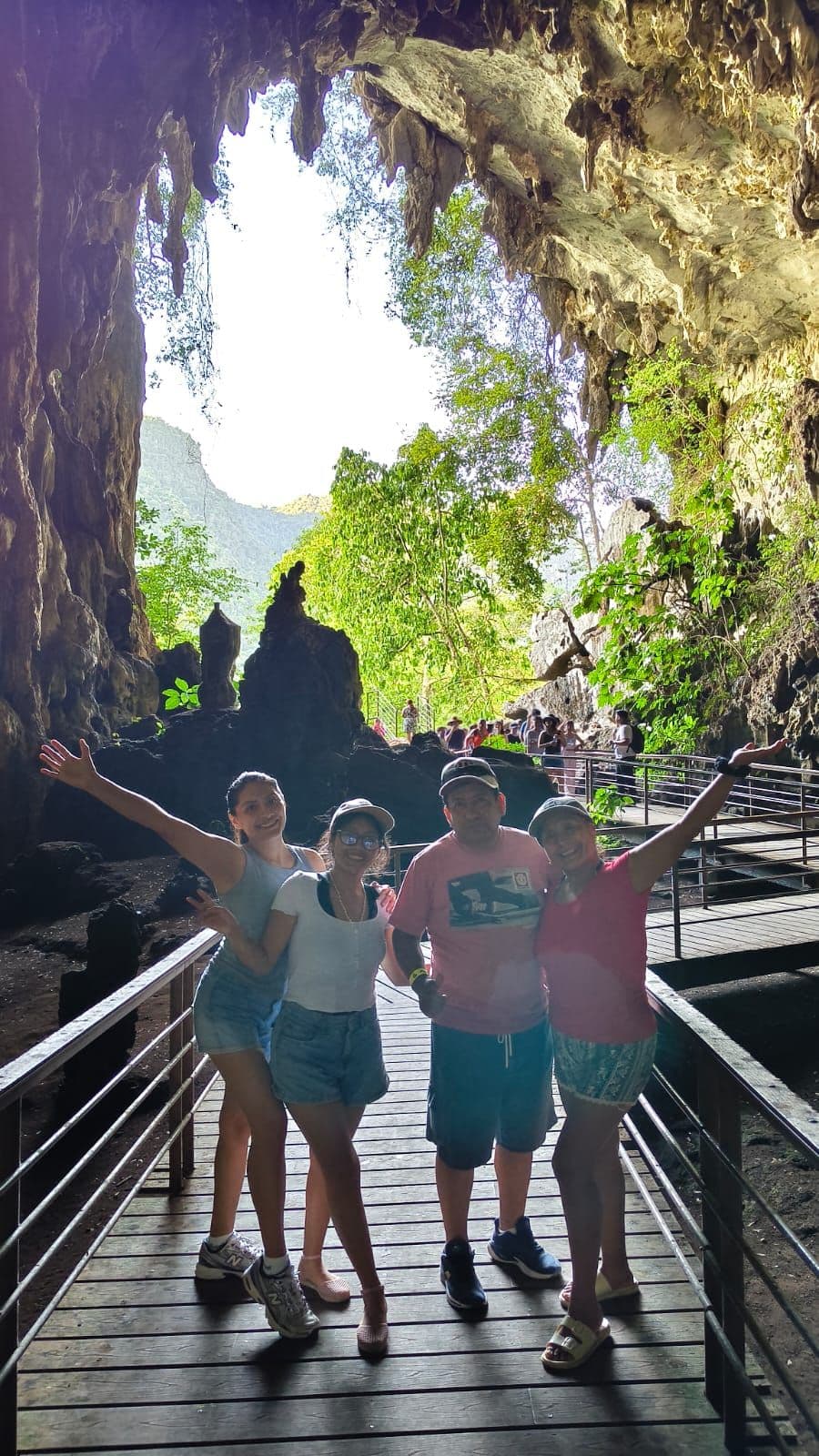 Visitors on the wooden walkway at the entrance of the Cueva de las Lechuzas, with light coming through the opening